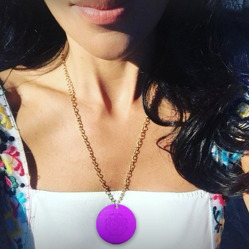 Tesla Purple energy Plate necklace with gold chain on woman with white top