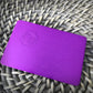 Tesla Purple plate wallet size plate on gray bamboo