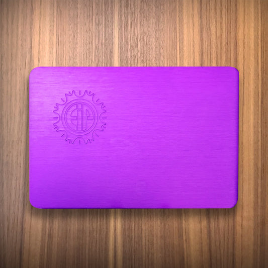 Wallet size purple energy plate on wood surface